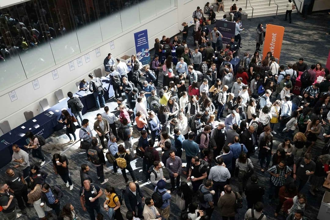 Rechtsanwälte netzwerken auf einer juristischen Fachkonferenz mit Messeständen im Hintergrund